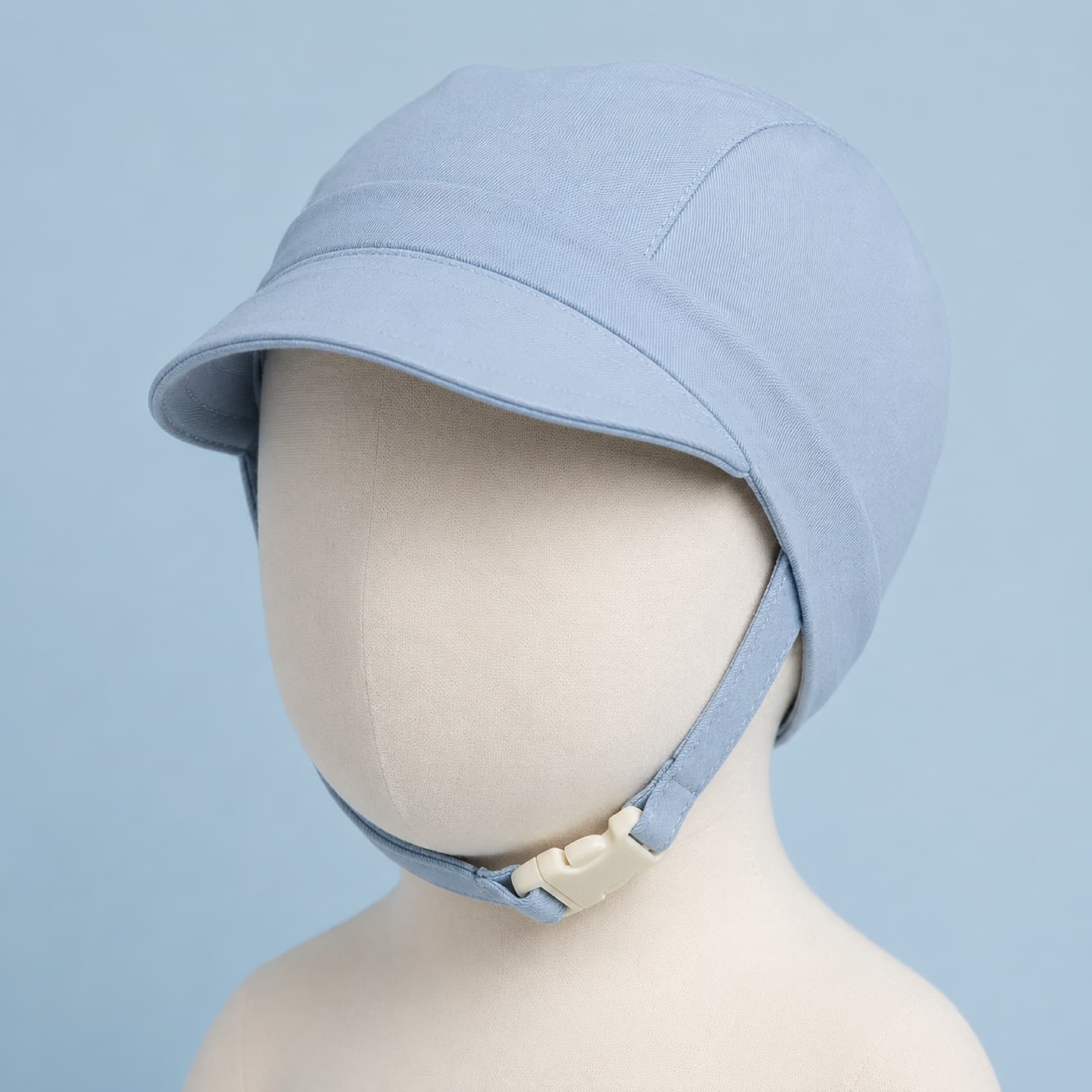 Sky-blue baby bonnet with a short front brim on a plain head form