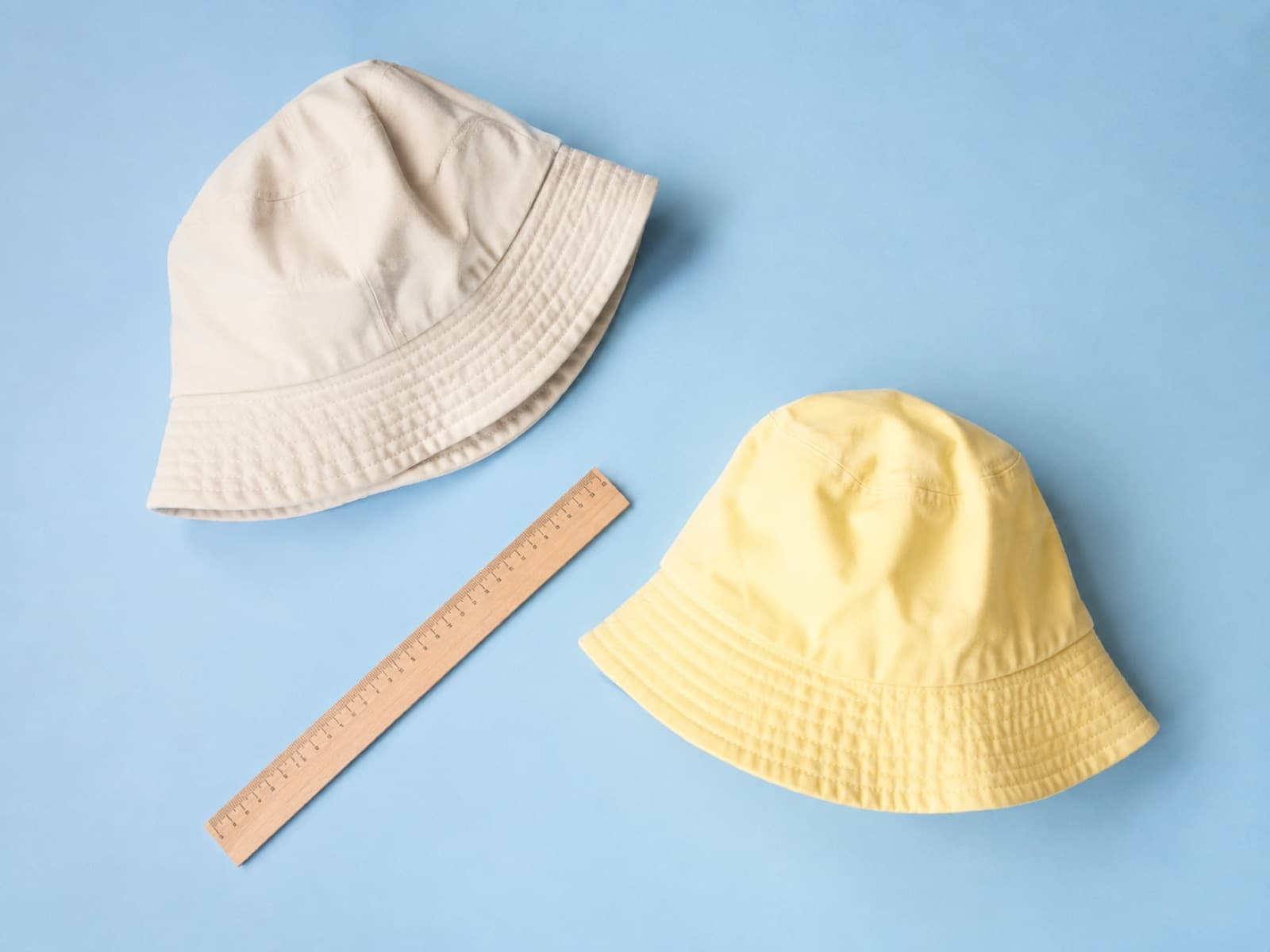 Two children's bucket hats in different sizes laid side by side