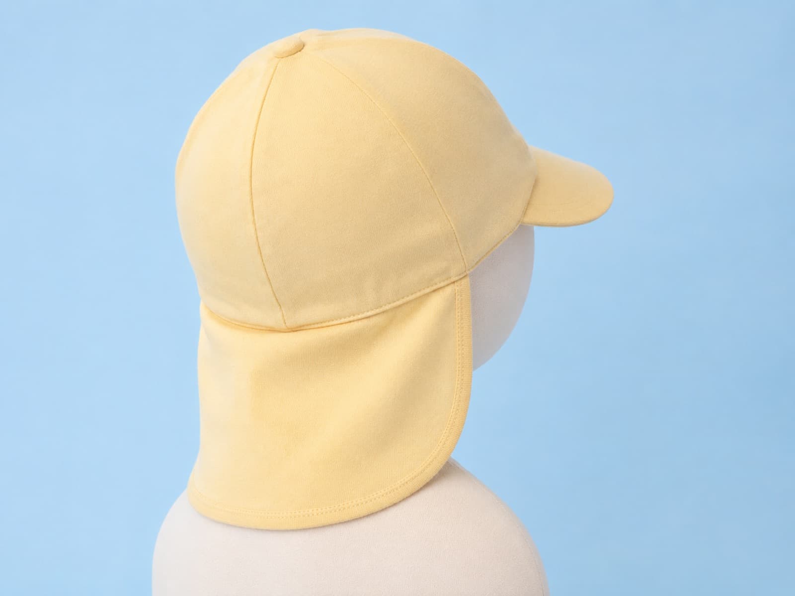 Toddler hat seen from behind with a long fabric neck flap