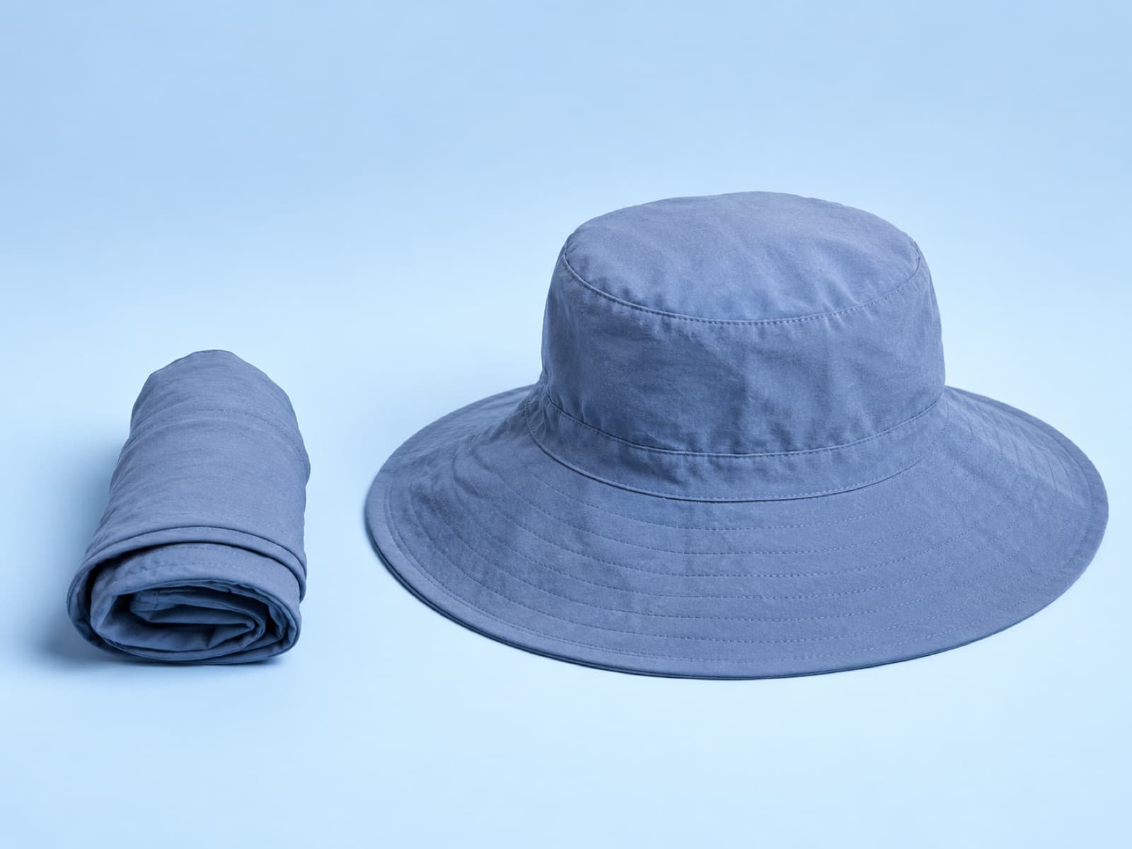 The packable adult hat rolled beside the same hat opened out